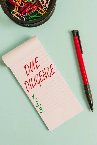 Writing note showing Due Diligence. Business photo showcasing Comprehensive Appraisal Voluntary Investigation Audit Notebook and stationary with mouse above pastel backdrop.