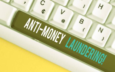 El yazısı metin Anti Money Underundering. Kavram anlamı düzenlemeler yasadışı eylemler le gelir elde etmeyi durdurmak Beyaz pc klavye beyaz arka plan anahtar kopyalama alanı üzerinde boş not kağıdı ile.