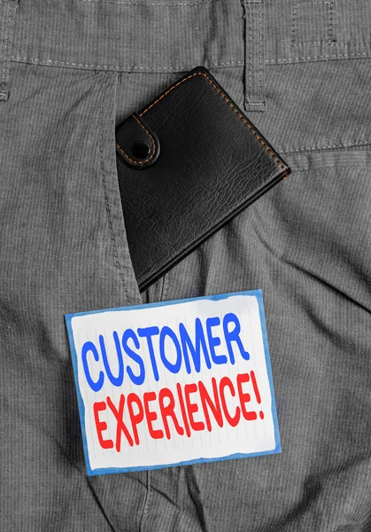 Handwriting text Customer Experience. Concept meaning product of interaction between organization and buyer Small little wallet inside man trousers front pocket near notation paper. — Stock Photo, Image