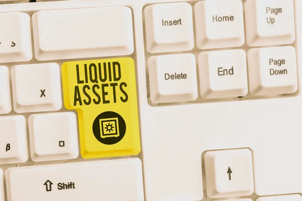 Handwriting text Liquid Assets. Concept meaning Cash and Bank Balances Market Liquidity Deferred Stock White pc keyboard with empty note paper above white background key copy space. — Stock Photo, Image