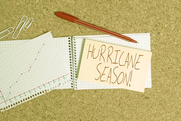 Word writing text Hurricane Season. Business concept for time when most tropical cyclones are expected to develop Desk notebook paper office cardboard paperboard study supplies table chart. — Stock Photo, Image