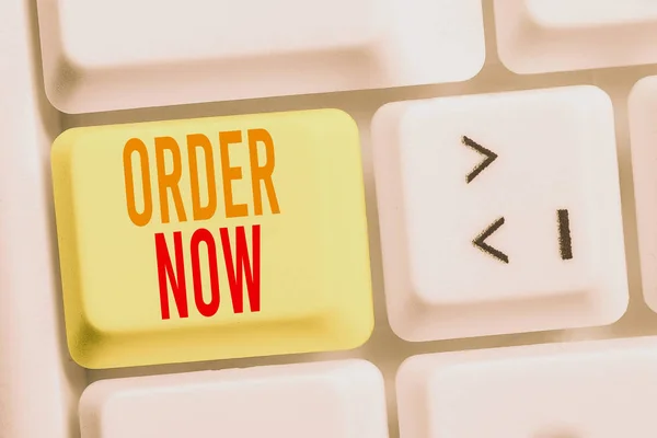 Handwriting text writing Order Now. Concept meaning the activity of asking for goods or services from a company White pc keyboard with empty note paper above white background key copy space.