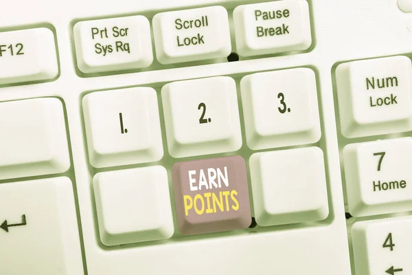 Conceptual hand writing showing Earn Points. Business photo showcasing getting praise or approval for something you have done White pc keyboard with note paper above the white background.