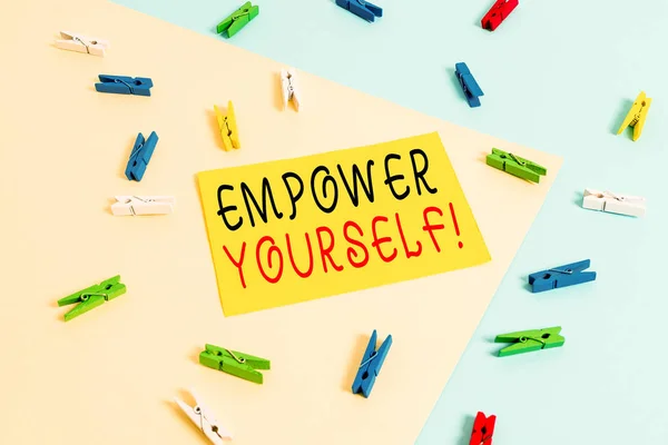 Text sign showing Empower Yourself. Conceptual photo taking control of our life setting goals and making choices Colored clothespin paper empty reminder yellow blue floor background office. — Stock Photo, Image