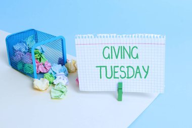 Text sign showing Giving Tuesday. Conceptual photo international day of charitable giving Hashtag activism Trash bin crumpled paper clothespin empty reminder office supplies tipped. clipart