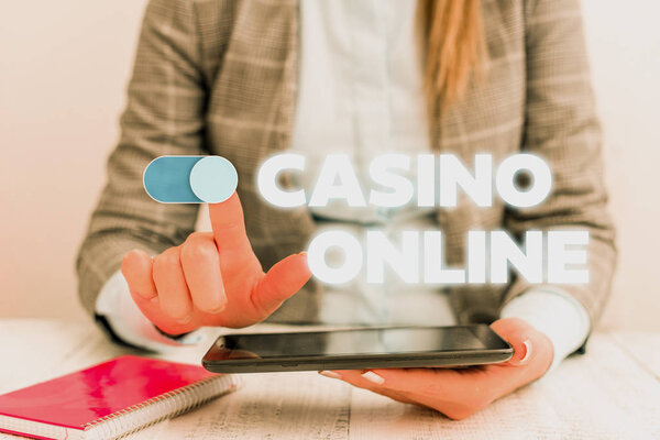 Conceptual hand writing showing Casino Online. Business photo showcasing Computer Poker Game Gamble Royal Bet Lotto High Stakes Business concept with communication mobile phone.