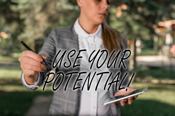 Text sign showing Use Your Potential. Conceptual photo achieve as much natural ability makes possible Outdoor background with business woman holding lap top and pen.