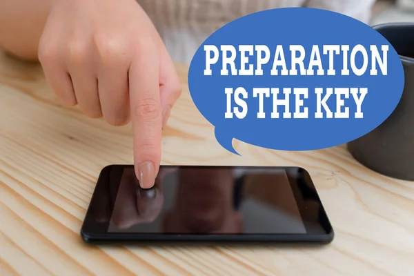 Text sign showing Preparation Is The Key. Conceptual photo it reduces errors and shortens the activities woman using smartphone office supplies technological devices inside home.