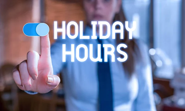 Text sign showing Holiday Hours. Conceptual photo Schedule 24 or7 Half Day Today Last Minute Late Closing Blurred woman in the background pointing with finger in empty space.