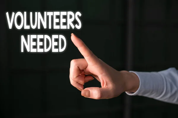 Writing note showing Volunteers Needed. Business photo showcasing need work or help for organization without being paid Finger pointing in the Dark with hand pointing in the copy space.