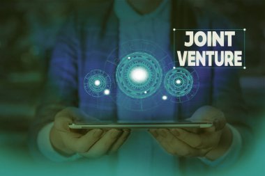 El yazısı metin yazma Joint Venture. Kavram anlamı İşbirliği Düzenleme Taraflar Ortaklık Takım Kadın akıllı cihaz kullanarak sunum sunan resmi iş elbisesi giymek.