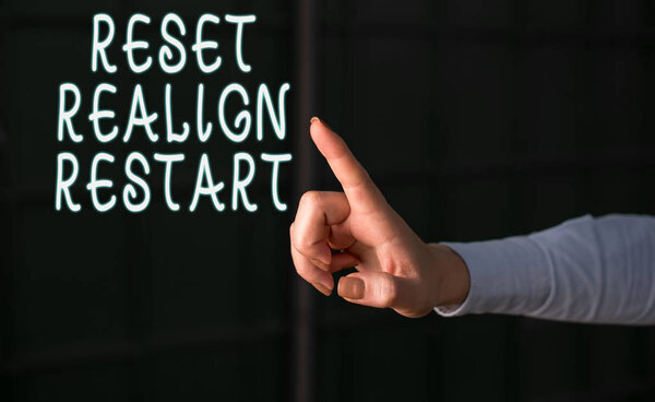 Handwriting text Reset Realign Restart. Concept meaning Life audit will help you put things in perspectives Finger pointing in the Dark with hand pointing in the copy space.