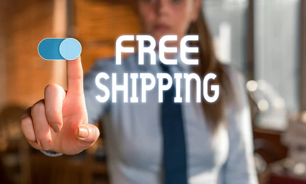 Text sign showing Free Shipping. Conceptual photo Freight Cargo Consignment Lading Payload Dispatch Cartage Blurred woman in the background pointing with finger in empty space. — 스톡 사진