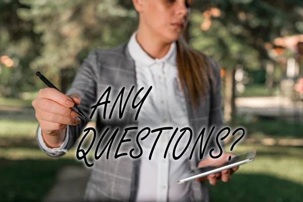 Text sign showing Any Questions Question. Conceptual photo you say write order to ask demonstrating about something Outdoor background with business woman holding lap top and pen.