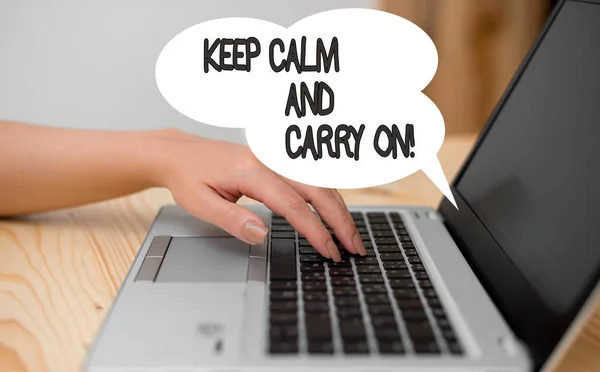 Writing note showing Keep Calm And Carry On. Business photo showcasing slogan calling for persistence face of challenge woman with laptop smartphone and office supplies technology.
