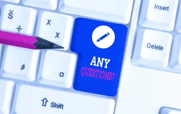 Writing note showing Any Questions Question. Business photo showcasing you say write order to ask demonstrating about something White pc keyboard with note paper above the white background.