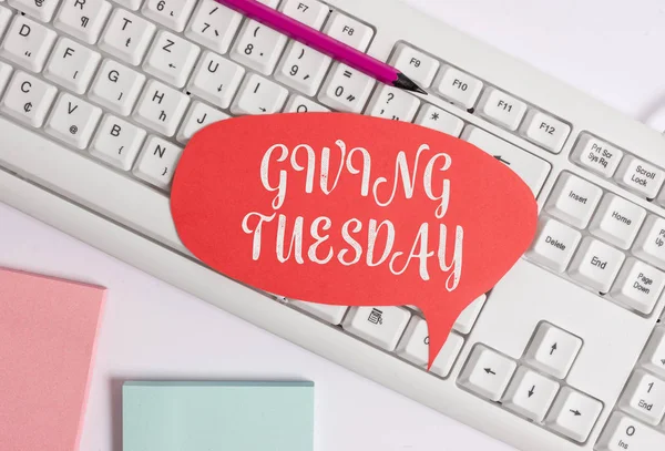 Writing note showing Giving Tuesday. Business photo showcasing international day of charitable giving Hashtag activism Empty copy space red note paper above pc keyboard for text message.