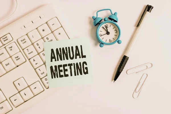 Conceptual hand writing showing Annual Meeting. Business photo text yearly meeting of the general membership of an organization White pc keyboard with empty note paper above white background.