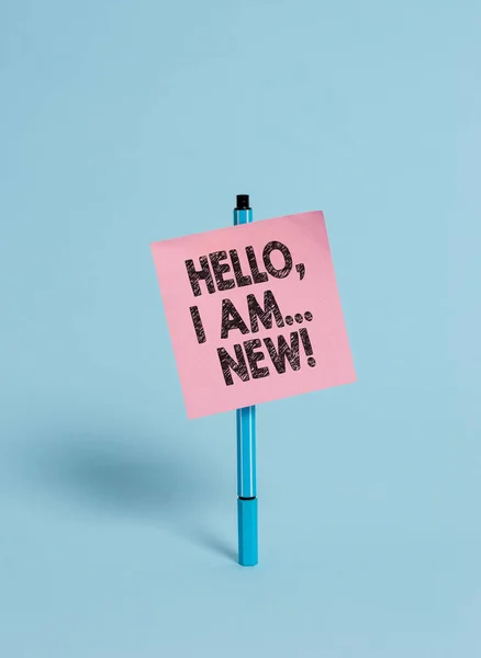 Handwriting text Hello I Am New. Concept meaning used greeting or begin telephone conversation Ballpoint blank colored sticky note peaceful cool pastel fashion background.
