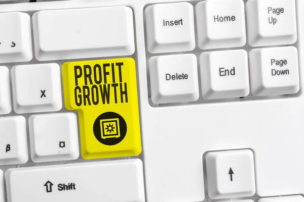 Handwriting text Profit Growth. Concept meaning Objectives Interrelation of Overall Sales Market Shares White pc keyboard with empty note paper above white background key copy space.