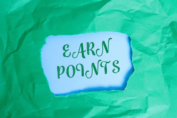 Text sign showing Earn Points. Conceptual photo getting praise or approval for something you have done Green crumpled ripped colored paper sheet centre torn colorful background.