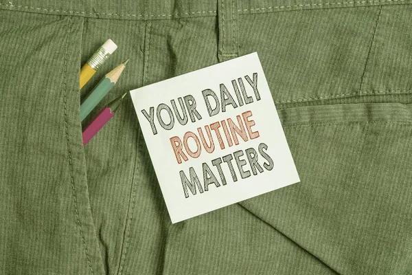 Handwriting text Your Daily Routine Matters. Concept meaning practice of regularly doing things in fixed order Writing equipment and blue note paper inside pocket of man work trousers.