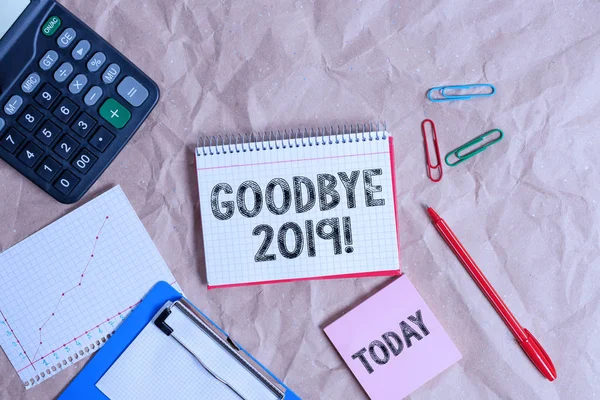 Writing note showing Goodbye 2019. Business photo showcasing express good wishes when parting or at the end of last year Papercraft desk square spiral notebook office study supplies.