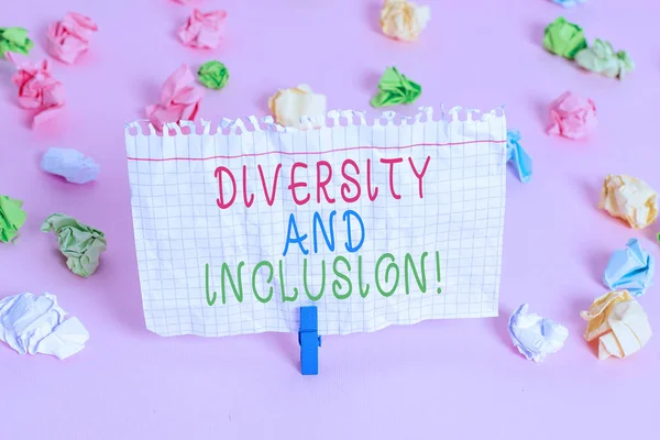 Conceptual hand writing showing Diversity And Inclusion. Business photo showcasing range huanalysis difference includes race ethnicity gender Colored crumpled papers empty reminder pink floor