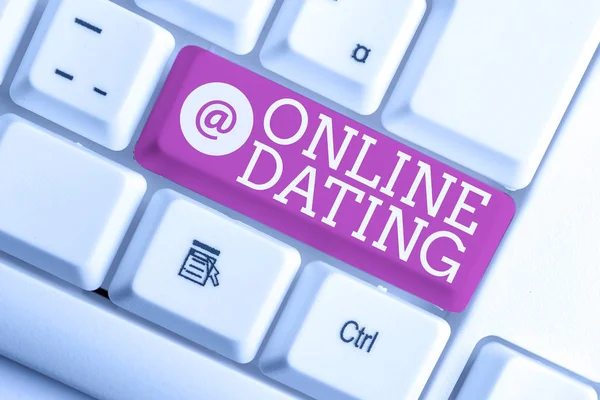 Writing note showing Online Dating. Business photo showcasing Searching Matching Relationships eDating Video Chatting White pc keyboard with note paper above the white background. — Stock Photo, Image