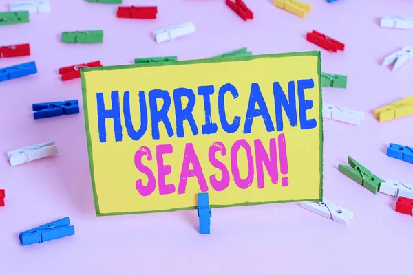 Word writing text Hurricane Season. Business concept for time when most tropical cyclones are expected to develop Colored clothespin papers empty reminder pink floor background office pin.
