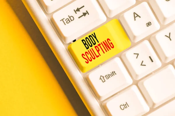 Handwriting text writing Body Sculpting. Concept meaning activity of increasing the body s is visible muscle tone White pc keyboard with empty note paper above white background key copy space.