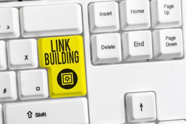 Handwriting text Link Building. Concept meaning SEO Term Exchange Links Acquire Hyperlinks Indexed White pc keyboard with empty note paper above white background key copy space. clipart