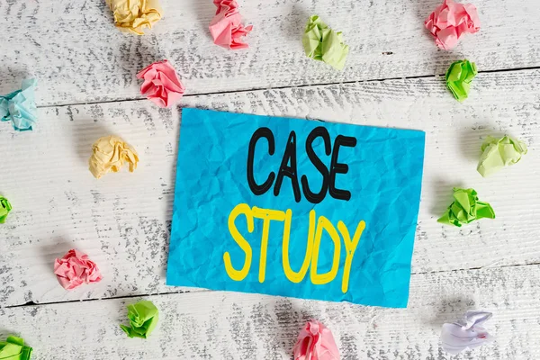 Word writing text Case Study. Business concept for analysis and a specific research design for examining a problem Crumpled colored rectangle square shaped paper reminder white wood desk.