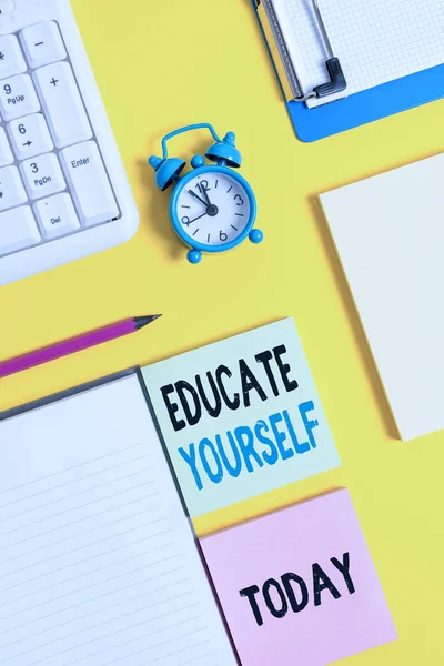 Conceptual hand writing showing Educate Yourself. Business photo text prepare oneself or someone in a particular area or subject Crumpled white paper on table clock mobile and pc keyboard. — Stock Photo, Image
