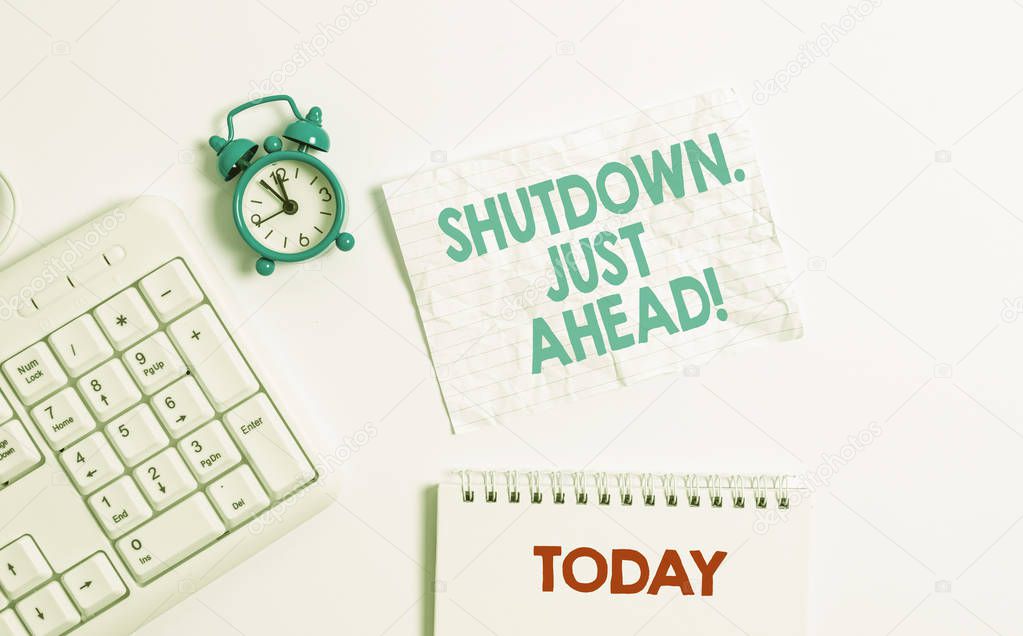 Text sign showing Shutdown Just Ahead. Conceptual photo closing factory business either short time or forever Blank paper with copy space on the table with clock and pc keyboard.