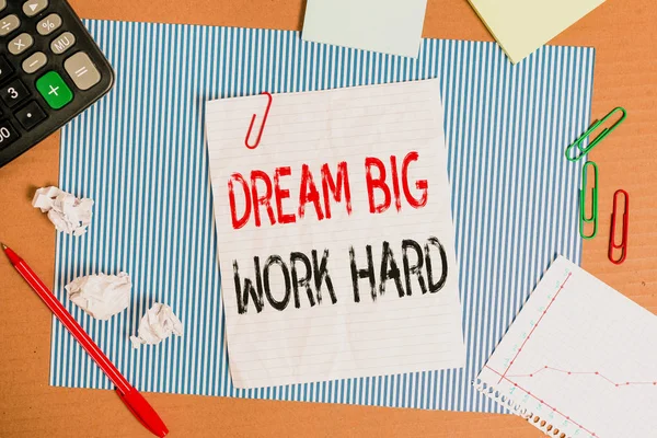 Text sign showing Dream Big Work Hard. Conceptual photo Believe in yourself and follow the dreams and goals Striped paperboard notebook cardboard office study supplies chart paper.