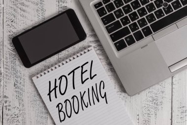 El yazısı metin Otel Rezervasyon. Konsept anlamı Online Rezervasyonlar Presidential Suite De Luxe Hospitality Metalik dizüstü boş eski ahşap masa yalan not defteri akıllı telefon hüküm.