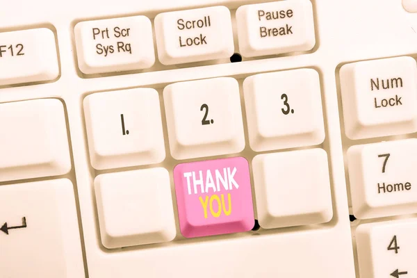 Conceptual hand writing showing Thank You. Business photo showcasing a polite expression used when acknowledging a gift or service White pc keyboard with note paper above the white background. — Stock Photo, Image
