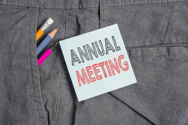 Handwriting text Annual Meeting. Concept meaning yearly meeting of the general membership of an organization Writing equipment and blue note paper inside pocket of man work trousers.