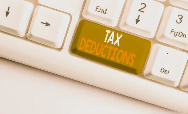 Text sign showing Tax Deductions. Conceptual photo an amount or cost that subtracted from someone s is income White pc keyboard with empty note paper above white background key copy space. — Stock Photo, Image