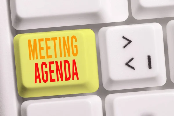 Handwriting text writing Meeting Agenda. Concept meaning items that participants hope to accomplish at a meeting White pc keyboard with empty note paper above white background key copy space.