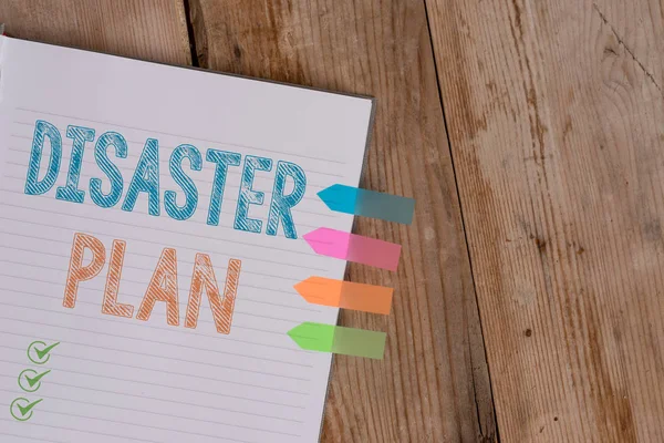 Handwriting text writing Disaster Plan. Concept meaning Respond to Emergency Preparedness Survival and First Aid Kit Striped note book four colored arrow banners reminder wooden background. — Stock Photo, Image