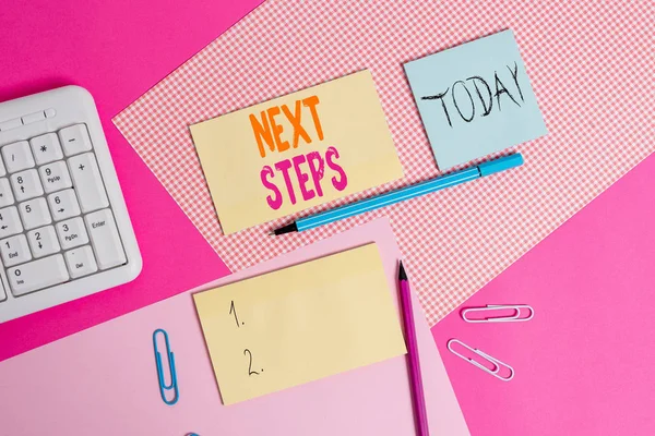 Handwriting text Next Steps. Concept meaning something you do or plan after you ve finished something else Writing equipments and computer stuffs placed above colored plain table. — Stock Photo, Image