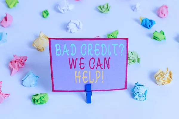 Writing note showing Bad Credit Question We Can Help. Business photo showcasing offering help after going for loan then rejected Colored crumpled paper empty reminder white floor clothespin.