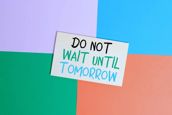 Text sign showing Do Not Wait Until Tomorrow. Conceptual photo needed to do it right away Urgent Better do now Office appliance colorful square desk study supplies empty paper sticker.