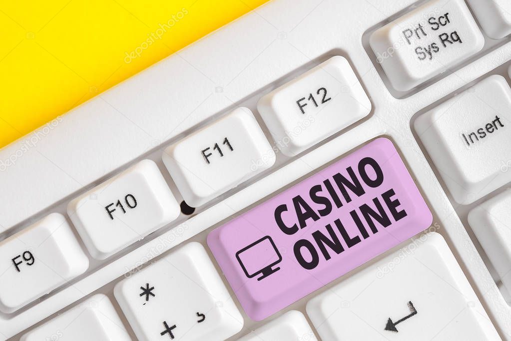 Writing note showing Casino Online. Business photo showcasing Computer Poker Game Gamble Royal Bet Lotto High Stakes White pc keyboard with note paper above the white background.
