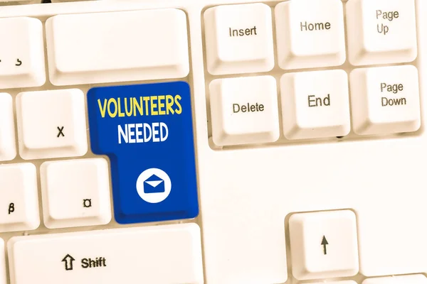 Word writing text Volunteers Needed. Business concept for need work or help for organization without being paid White pc keyboard with empty note paper above white background key copy space.