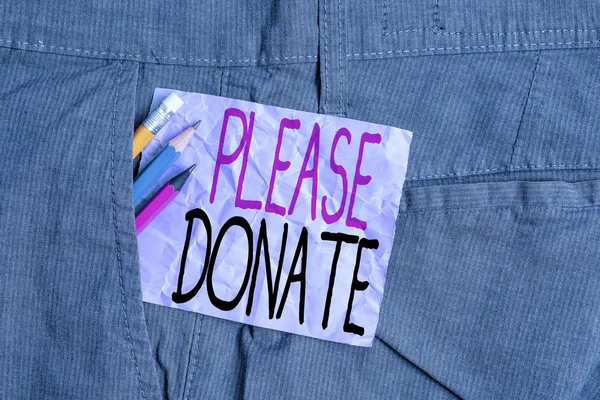 Conceptual hand writing showing Please Donate. Business photo text Supply Furnish Hand out Contribute Grant Aid to Charity Writing equipment and purple note paper inside pocket of trousers.