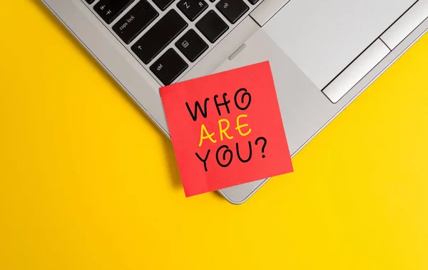 Writing note showing Who Are Youquestion. Business photo showcasing someone asking your demonstratingal background or history Metallic trendy laptop blank sticky note empty text colored background.