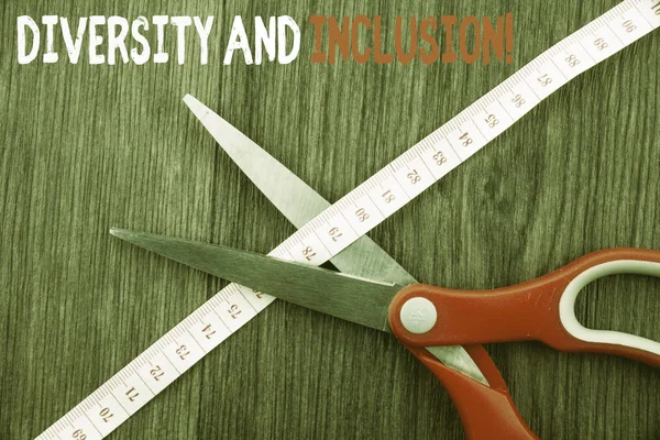 Word writing text Diversity And Inclusion. Business concept for range huanalysis difference includes race ethnicity gender Front view wooden background scissors cutting through tape measuring diet.